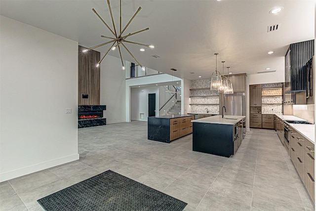 1012 Impala Dr, Granite Shoals, TX 78654 - kitchen with a chandelier, tasteful backsplash, a large island with sink, a sink, and open floor plan