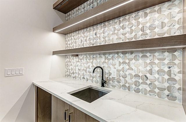 1012 Impala Dr, Granite Shoals, TX 78654 - kitchen with open shelves, light stone counters, decorative backsplash, and a sink