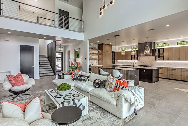 1012 Impala Dr, Granite Shoals, TX 78654 - living room featuring light tile patterned flooring, stairs, and a high ceiling