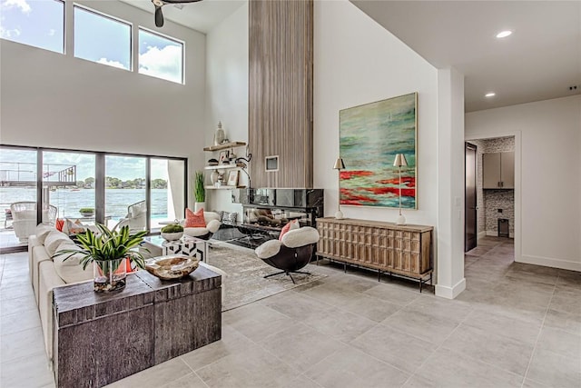 1012 Impala Dr, Granite Shoals, TX 78654 - living room with a high ceiling, light tile patterned flooring, recessed lighting, and a water view