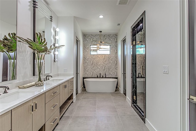 1012 Impala Dr, Granite Shoals, TX 78654 - bathroom with a freestanding tub, double vanity, wallpapered walls, and recessed lighting