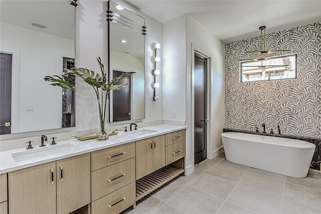 1012 Impala Dr, Granite Shoals, TX 78654 - full bath featuring wallpapered walls, double vanity, a soaking tub, and tile patterned flooring