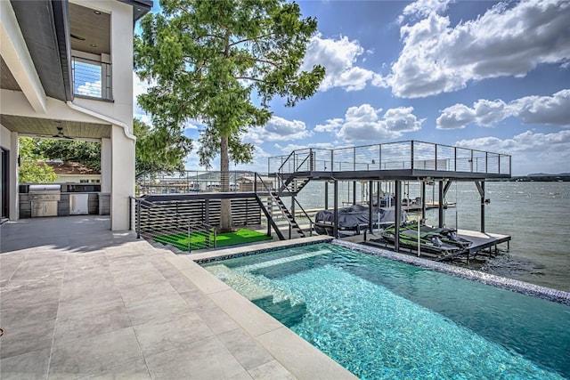 1012 Impala Dr, Granite Shoals, TX 78654 - outdoor pool with boat lift, an outdoor kitchen, a dock, stairs, and a water view