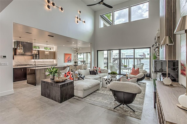 1012 Impala Dr, Granite Shoals, TX 78654 - living room with a high ceiling, ceiling fan, and a chandelier