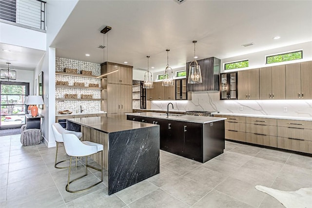 1012 Impala Dr, Granite Shoals, TX 78654 - kitchen featuring a spacious island, decorative backsplash, a chandelier, glass insert cabinets, and recessed lighting
