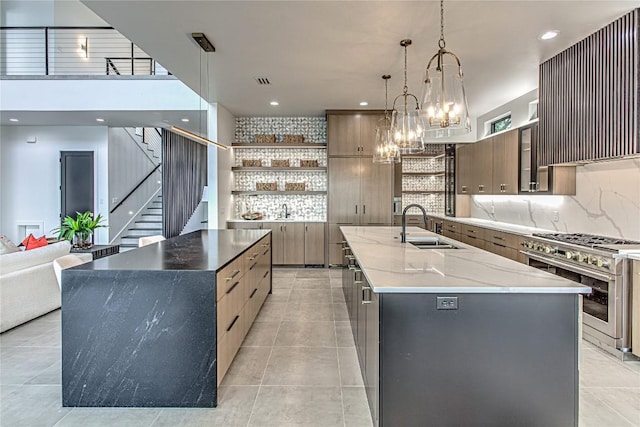1012 Impala Dr, Granite Shoals, TX 78654 - kitchen featuring high end stainless steel range oven, a large island, open shelves, modern cabinets, and recessed lighting