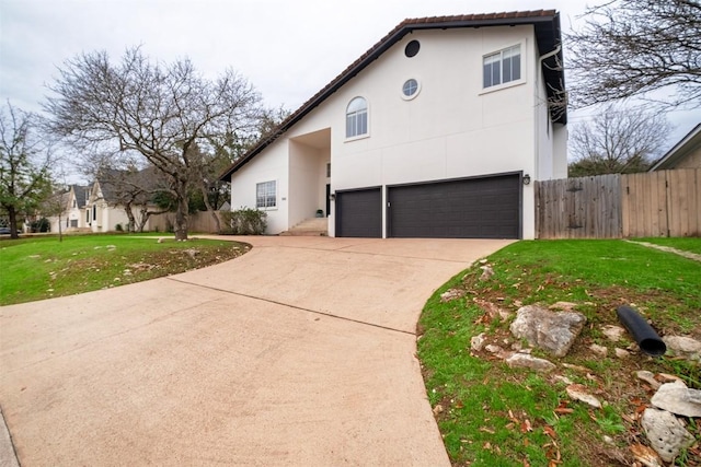 1302 Olympus Dr, Austin, TX 78733 - view of property exterior featuring an attached garage, driveway, and stucco siding