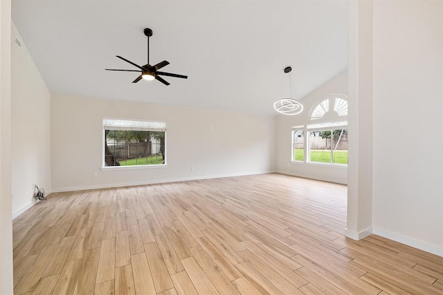 1302 Olympus Dr, Austin, TX 78733 - empty room with light wood-type flooring, lofted ceiling, ceiling fan, baseboards, and a chandelier