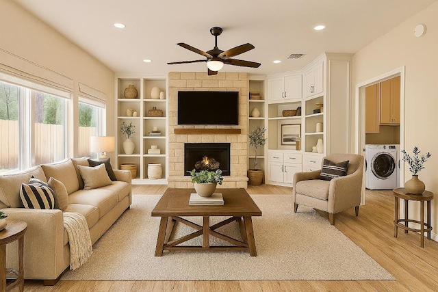 1302 Olympus Dr, Austin, TX 78733 - living room with light wood-style floors, a ceiling fan, recessed lighting, a stone fireplace, and built in shelves