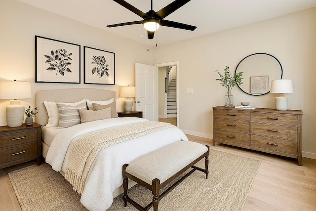 1302 Olympus Dr, Austin, TX 78733 - bedroom featuring baseboards, light wood-style flooring, and a ceiling fan