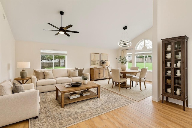 1302 Olympus Dr, Austin, TX 78733 - living area with ceiling fan, high vaulted ceiling, and light wood-style flooring