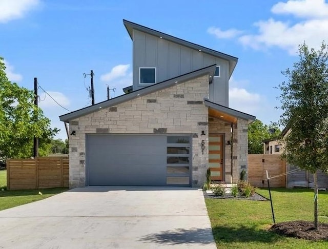 501 E Burton St, Manor, TX 78653 - view of property exterior with board and batten siding, concrete driveway, stone siding, and a garage
