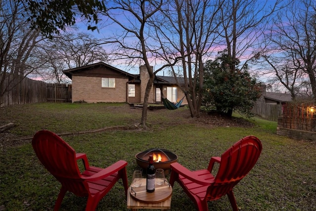 yard at dusk with an outdoor fire pit