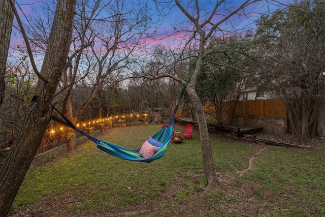 playground at dusk featuring a yard