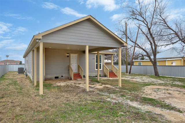 back of house with central AC unit