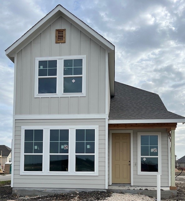 view of front of home featuring a shingled roof and board and batten siding