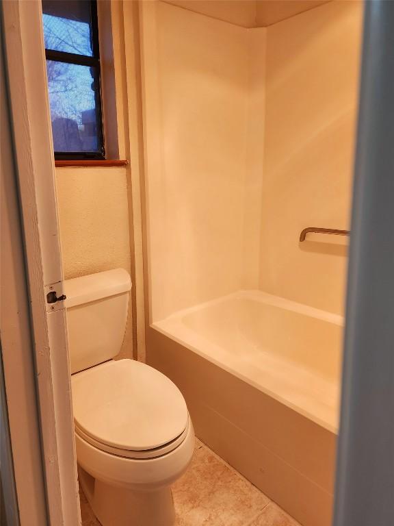 bathroom featuring tile patterned floors and toilet