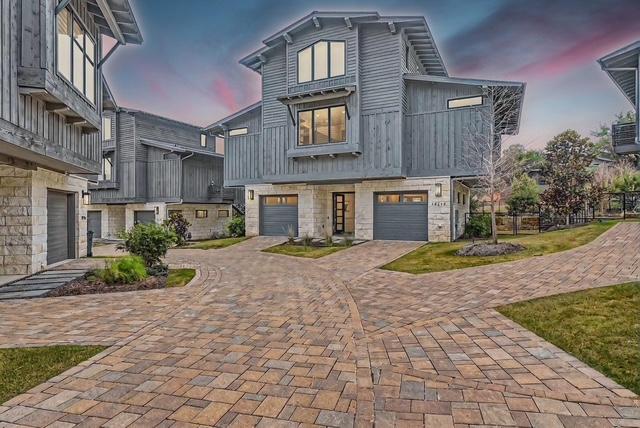 19217 Lost Tree Cv, Spicewood, TX 78669 - view of front of home featuring decorative driveway, an attached garage, and stone siding