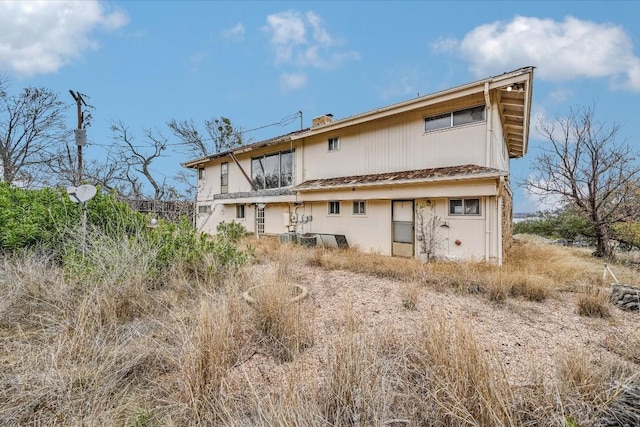 back of property featuring a chimney