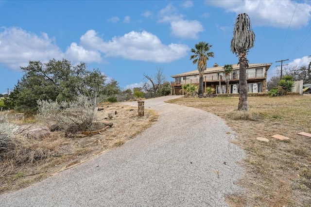 view of front of property with driveway and a deck