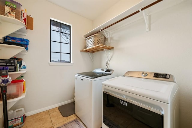 laundry area featuring light tile patterned floors and washer and clothes dryer