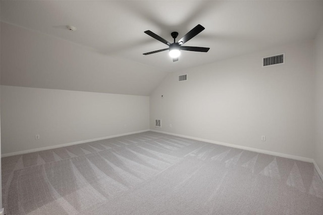 additional living space with vaulted ceiling, ceiling fan, and carpet