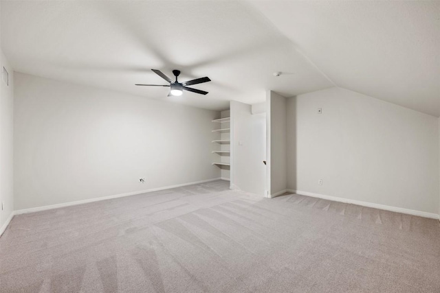 bonus room with lofted ceiling, light carpet, and ceiling fan