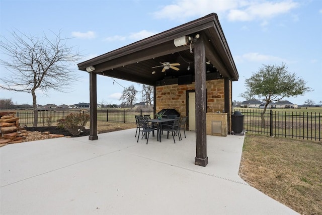 view of patio featuring a fireplace and ceiling fan