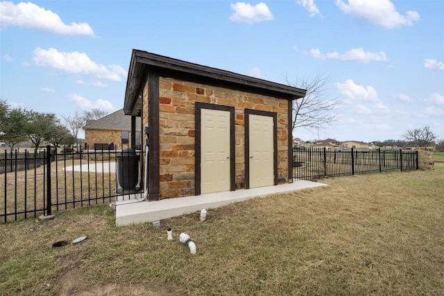 view of outbuilding featuring a lawn