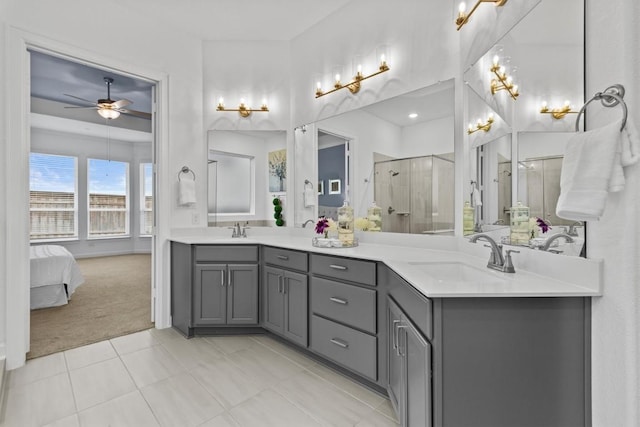872 Wild Pecan Loop, Buda, TX 78610 - bathroom with double vanity, ceiling fan, a shower stall, tile patterned floors, and ensuite bath
