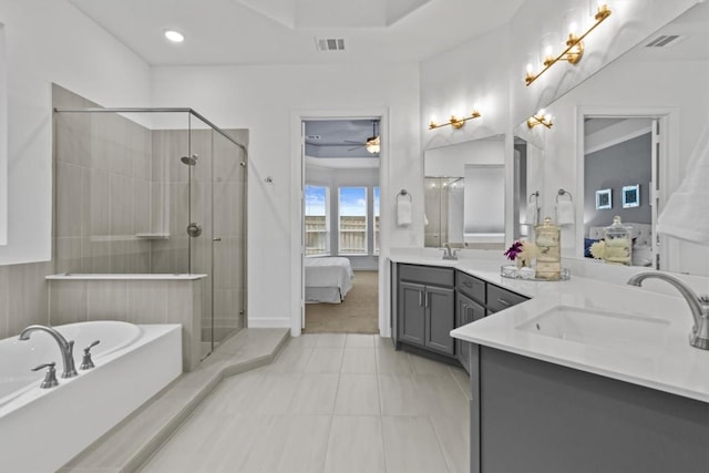 872 Wild Pecan Loop, Buda, TX 78610 - ensuite bathroom with a bath, double vanity, a stall shower, ceiling fan, and recessed lighting