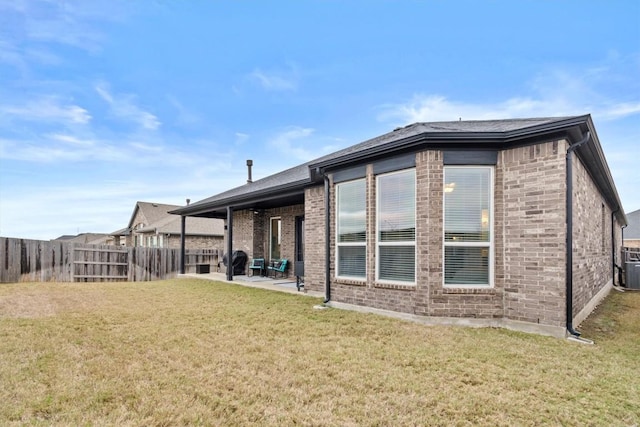 872 Wild Pecan Loop, Buda, TX 78610 - rear view of house with brick siding and a patio area