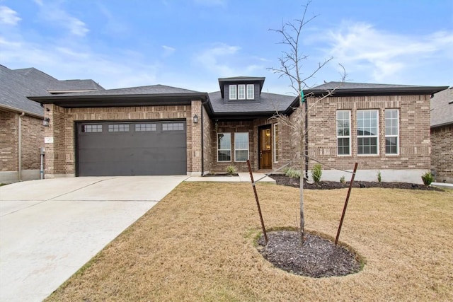 872 Wild Pecan Loop, Buda, TX 78610 - view of front of house with brick siding, concrete driveway, a front yard, and a garage