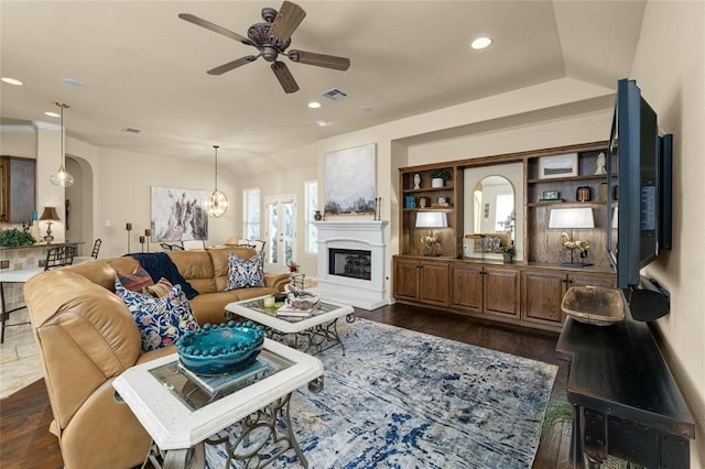 11409 Cezanne Ct, Austin, TX 78726 - living area with ceiling fan, a glass covered fireplace, arched walkways, dark wood finished floors, and recessed lighting