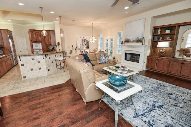 11409 Cezanne Ct, Austin, TX 78726 - living area with wood-type flooring, a ceiling fan, a glass covered fireplace, recessed lighting, and a chandelier