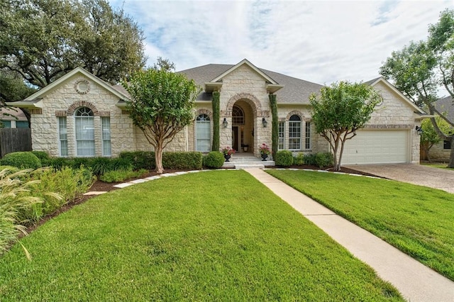 ranch-style house with a garage and a front yard