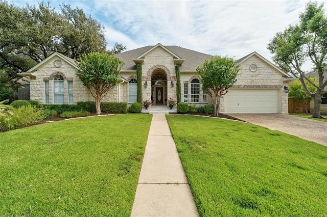 11409 Cezanne Ct, Austin, TX 78726 - view of front of house featuring stone siding, an attached garage, a front lawn, and concrete driveway