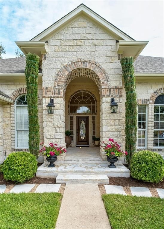 11409 Cezanne Ct, Austin, TX 78726 - doorway to property with stone siding and roof with shingles