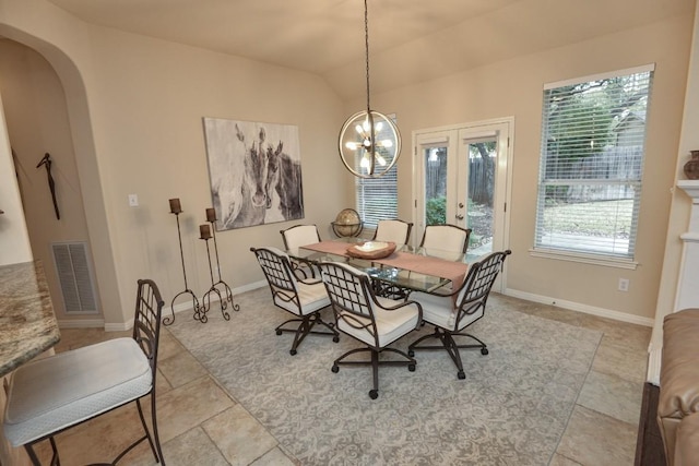 11409 Cezanne Ct, Austin, TX 78726 - dining area featuring arched walkways, french doors, lofted ceiling, a chandelier, and baseboards