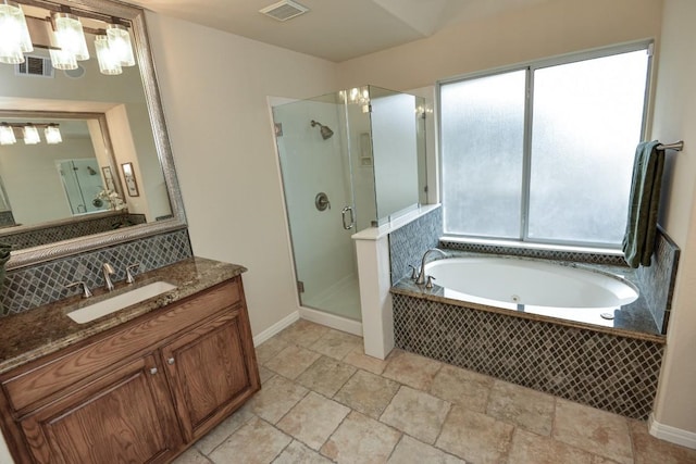11409 Cezanne Ct, Austin, TX 78726 - bathroom with a shower stall, vanity, a tub with jets, backsplash, and stone tile flooring