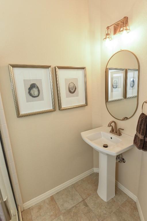 11409 Cezanne Ct, Austin, TX 78726 - full bathroom with baseboards, an enclosed shower, and tile patterned floors