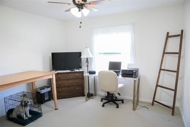 carpeted office space with ceiling fan