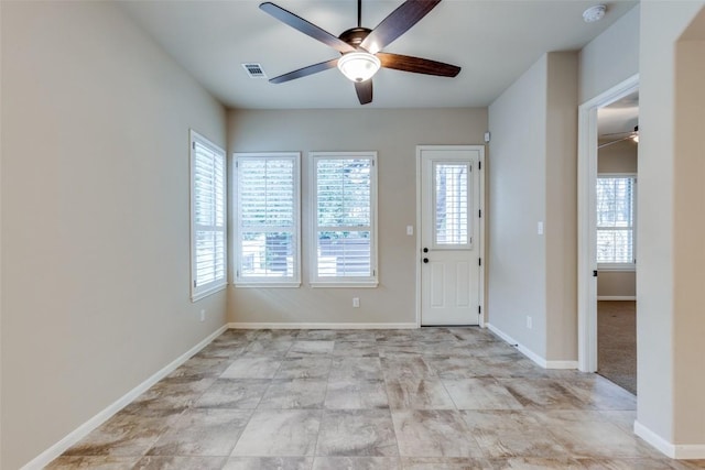 entrance foyer featuring ceiling fan and a healthy amount of sunlight