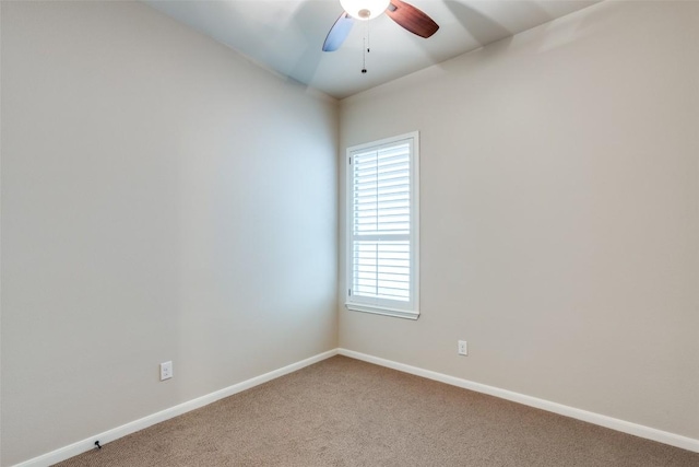 carpeted spare room featuring ceiling fan