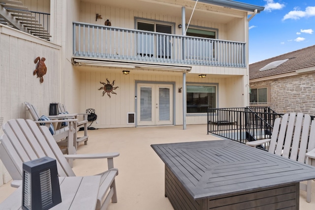 view of patio / terrace featuring french doors and a balcony