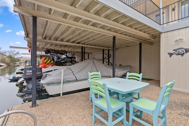 view of patio featuring a balcony and a water view