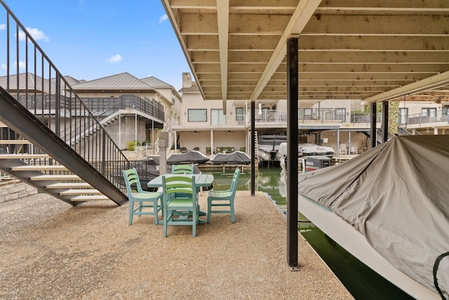 view of patio featuring a dock and a water view