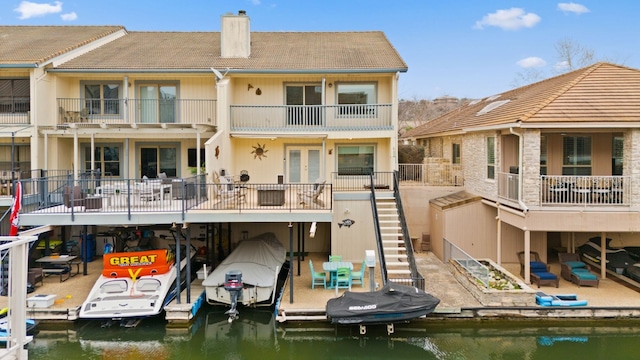 back of house featuring a water view