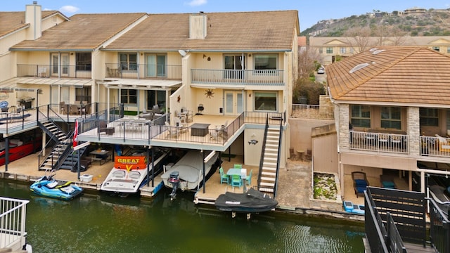 rear view of property featuring a water and mountain view