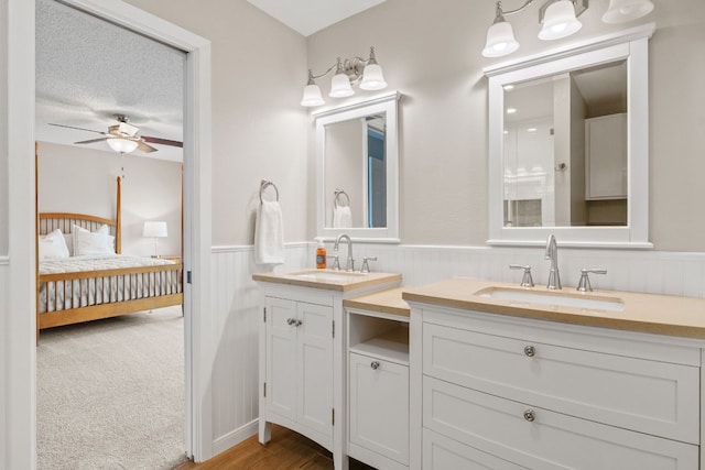 bathroom with vanity, a textured ceiling, and ceiling fan